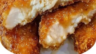 "Air fryer honey butter garlic chicken tenders with crispy golden coating and savory glaze, served with dipping sauce on a plate"