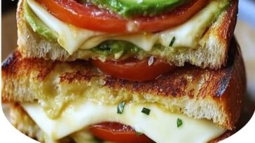 "Golden, crispy grilled cheese sandwich filled with creamy avocado, fresh mozzarella, and juicy tomato slices. A flavorful and healthy twist on the classic grilled cheese."