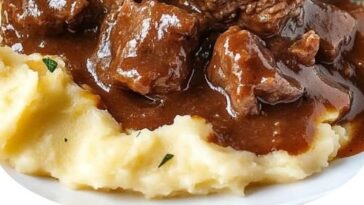"Braised beef in savory sauce served with creamy homemade puree, garnished with fresh herbs and vegetables."