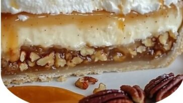 "Slice of caramel pecan delight pie with a golden, flaky crust, topped with rich caramel sauce and chopped pecans."