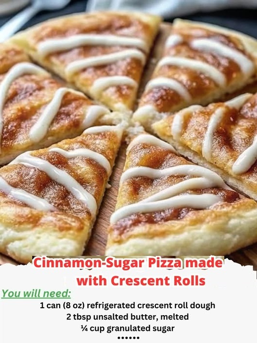 "Golden brown cinnamon-sugar pizza made with crescent roll dough, topped with a sweet vanilla icing drizzle."