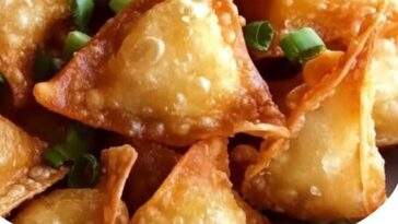 "Crispy crab rangoon with golden-brown crispy wrappers and a creamy filling inside."