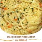 "Bowl of crack chicken noodle soup with tender chicken, noodles, creamy broth, and a sprinkle of cheese, garnished with fresh herbs."