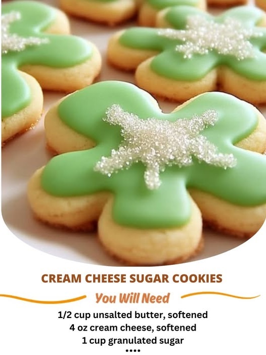 "Soft, sweet cream cheese sugar cookies topped with colorful sprinkles, freshly baked and placed on a plate."