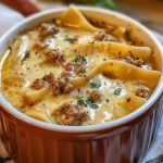 "A steaming bowl of creamy Alfredo lasagna soup with tender noodles, melted cheese, and a rich, creamy broth."