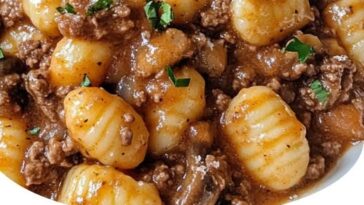 "Braised beef in savory sauce served with creamy homemade puree, garnished with fresh herbs and vegetables."
