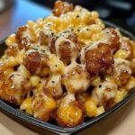 "Creamy Honey Pepper Chicken Mac and Cheese served in a bowl with melted cheese and a peppery glaze."
