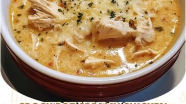 "Crock pot creamy chicken parmesan soup with a rich, creamy texture and topped with grated parmesan."