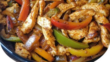 "Crockpot Chicken Fajitas: Tender chicken cooked with bell peppers and onions in a savory blend of spices, served as a delicious and easy weeknight dinner."