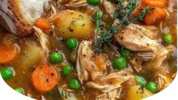 A bowl of hearty chicken and vegetable stew filled with tender chicken pieces, carrots, potatoes, and green beans, all simmered in a flavorful broth. The dish is garnished with fresh herbs for an extra touch of color and flavor.