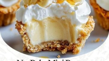 Mini no-bake banana cream pies served in individual graham cracker crusts, topped with a smooth layer of banana-flavored cream filling, fresh banana slices, and whipped cream. Each pie is garnished with a sprinkle of graham cracker crumbs for added texture.