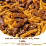 One-pot smoky honey BBQ steak pasta with tender steak, smoky BBQ sauce, and pasta, garnished with fresh herbs."