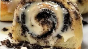 "Oreo stuffed cinnamon rolls with a soft, fluffy dough, Oreo cookie filling, and a drizzle of icing on top."