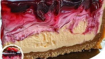 "Peanut Butter and Jelly Cheesecake with a nostalgic twist, topped with peanut butter and strawberry jelly swirl, served on a graham cracker crust."