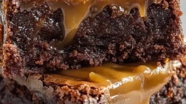 "Salted caramel brownies topped with a rich caramel drizzle, creating a decadent and irresistible dessert perfect for every occasion."