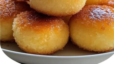Golden, bite-sized Southern-style cornbread poppers with a crispy exterior, drizzled with sweet honey butter. Each popper is perfectly fluffy inside and served in a small basket with a few more honey butter drizzles on top.