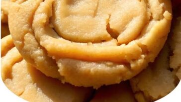 "Thick and chewy peanut butter cookies with a golden brown exterior and a soft, gooey center."