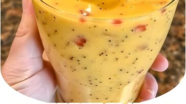 "Tropical Strawberry Mango Smoothie: A vibrant, refreshing blend of fresh strawberries and mangoes, topped with a hint of coconut for a fruity, tropical treat."
