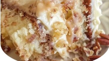"White German Chocolate Cake with a rich cheesecake center, topped with decadent chocolate and coconut frosting."