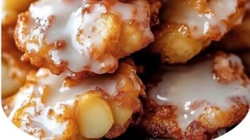 "Golden, warm baked apple fritters drizzled with sweet glaze, showcasing the crispy edges and soft, cinnamon-infused interior."