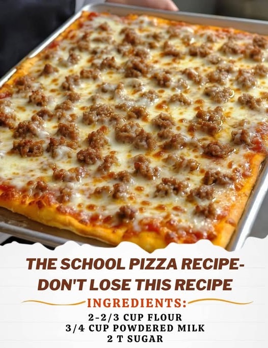 A slice of classic school pizza with a crispy golden crust, topped with tomato sauce, melted cheese, and a sprinkle of herbs, placed on a paper tray.