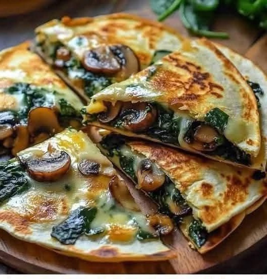 Golden, baked quesadillas filled with spinach, mushrooms, and melted cheese, served with a side of salsa.