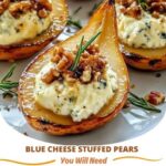 Blue Cheese Stuffed Pears served on a platter, with ripe pear halves filled with creamy blue cheese and garnished with fresh herbs and a drizzle of honey.