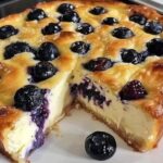 A delicious Blueberry Cottage Cheese Breakfast Bake served in a baking dish, topped with fresh blueberries and a light golden crust.