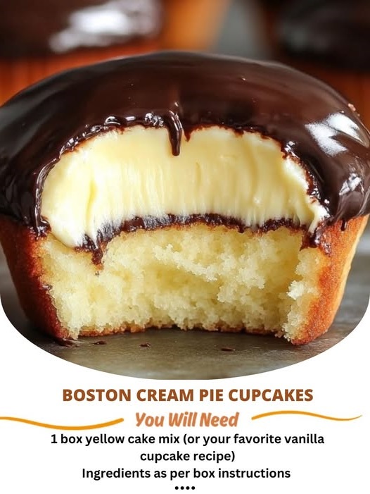A close-up of Boston Cream Pie Cupcakes, with a fluffy vanilla cupcake base, filled with creamy custard, and topped with a glossy layer of rich chocolate ganache.