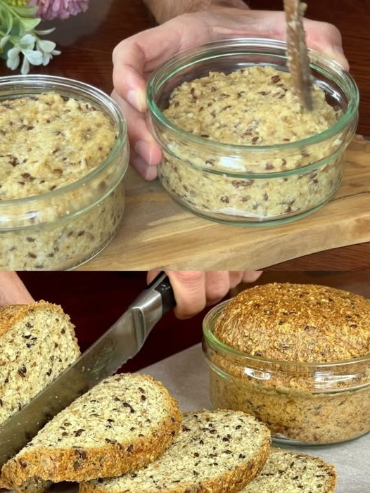 A small jar containing freshly baked bread, golden brown and fluffy, with a smooth crust and a rustic appearance, ready to be served.