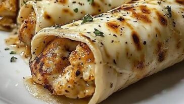 Cheesy Garlic Chicken Wraps, golden and crispy on the outside with melted cheese, tender chicken, and savory garlic filling inside.