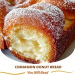 Slices of warm, golden-brown cinnamon donut bread, topped with a sugary cinnamon glaze, resting on a plate.