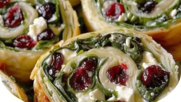 Colorful cranberry feta pinwheels with cream cheese, rolled into bite-sized swirls, showcasing vibrant red cranberries and creamy cheese filling.