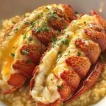 Succulent lobster tails and scallops drizzled with rich garlic butter, garnished with fresh herbs and served on a plate.