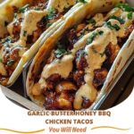 ender chicken tacos filled with juicy pieces of garlic butter honey BBQ chicken, topped with fresh cilantro and a drizzle of sauce, served on soft tortillas.