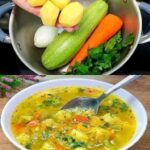 Healthy healing vegetable soup with carrots, zucchini, spinach, and sweet potato, garnished with fresh herbs.