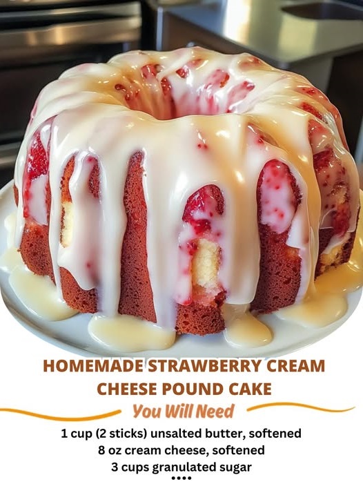 A freshly baked homemade strawberry cream cheese pound cake with a light pinkish hue, topped with slices of fresh strawberries and a creamy glaze.
