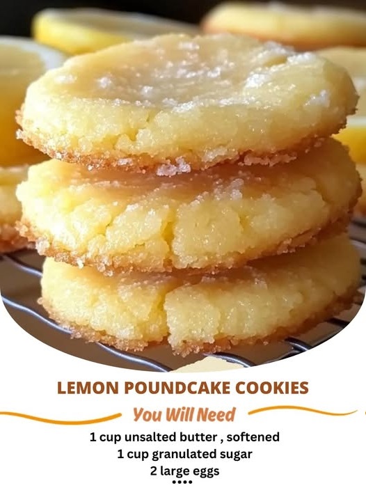 A plate of soft, golden lemon poundcake cookies with a light glaze, garnished with lemon zest and fresh mint leaves.