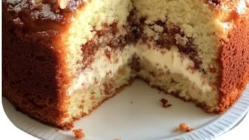 Moist cinnamon sugar nut cake topped with crunchy nuts and a dusting of cinnamon sugar