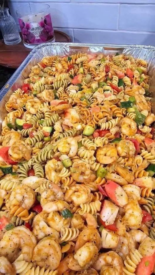 Colorful and refreshing pasta salad with shrimp, crab, fresh vegetables, and a light dressing, perfect for a summer meal.