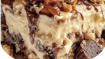 Decadent Peanut Butter Cup Dump Cake with layers of chocolate, peanut butter filling, and crumbled peanut butter cups on top.