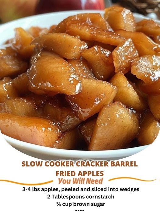 A bowl of Slow Cooker Cracker Barrel Fried Apples, caramelized with cinnamon and sugar, garnished with a sprinkle of cinnamon, served with a spoon, exuding a warm, comforting aroma.