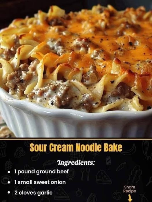A baked dish of sour cream noodle bake with creamy layers of pasta, ground meat, and cheese, topped with a golden-brown crust.