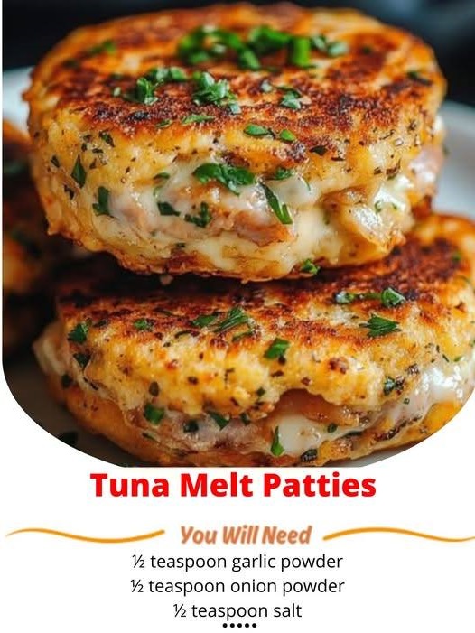 Golden-brown tuna melt patties with melted cheese on top, garnished with fresh herbs, placed on a plate