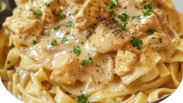 A plate of Crockpot Angel Chicken featuring tender chicken pieces in a creamy, savory sauce with a hint of seasoning.