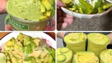 A creamy green avocado smoothie served in a glass with a straw, topped with chia seeds and surrounded by fresh avocado slices.