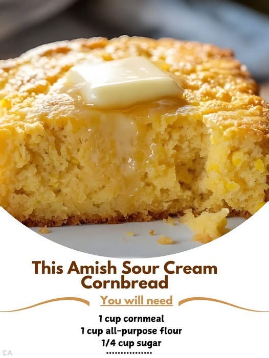 A warm slice of Amish Sour Cream Cornbread on a plate, with a golden crust and a moist, soft interior.