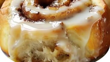 warm stack of banana bread cinnamon rolls drizzled with a creamy glaze, with swirls of cinnamon and banana filling visible inside.