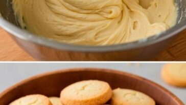 Golden butter shortbread cookies stacked neatly on a plate, with a light dusting of sugar on top.