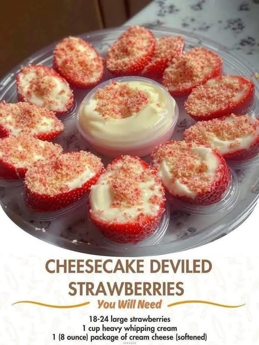 Halved strawberries filled with creamy cheesecake filling, piped in a swirl and topped with graham cracker crumbs.